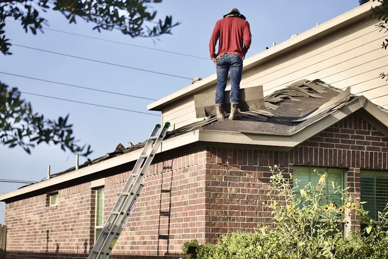 Professional roofer working on a residential roof in Meeting House Overlook